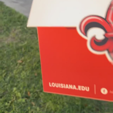 Someone pulling a Orientation registration card out of the mail