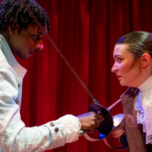 Two actors dueling on stage