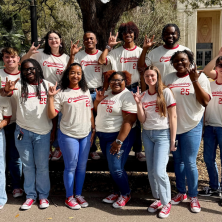 A group of students wearing white orientation shirts