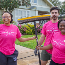 # student sin the pink The Big Event shirts doing service work