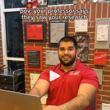 UL Lafayette student on his laptop smiling at the camera