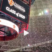 Class of 2029 on Cajundome jumbotron with red confetti blasting