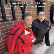 Two UL students sink into their jackets to mimic two birds whistling about homecoming.