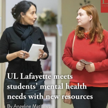 A UL student is talking to a UL counselor while grasping an informational packet