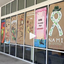 A group of student organization artwork is displayed on the Student Union windows