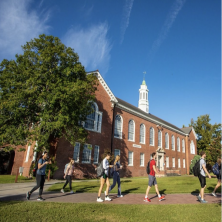 Students walk in front of a UL building on a sunny day