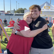 student hugs their parent during family weekend