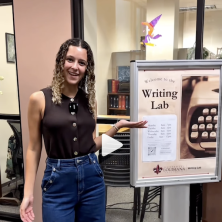 UL students point at the writing lab information sign
