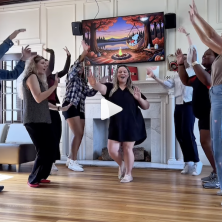 UL social media team dance in a soul train line in the french house