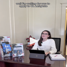 UL student sits at desk stating "Well I'm waiting for you to apply to UL Lafayette"
