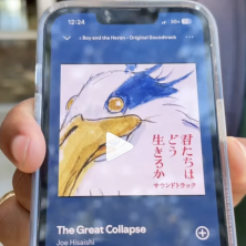 UL student holds a phone that shows "The Great Collapse" song