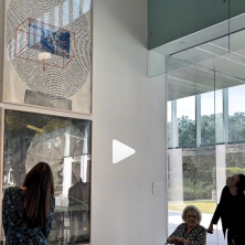 three individuals look at the Rauschenberg's Autobiography at the Hilliard Art Museum