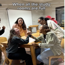 A group of UL students arm wrestle in one of the library's study rooms