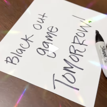 Sign reads "Black out game tomorrow!"