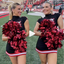 Two UL cheerleaders strut down the football field