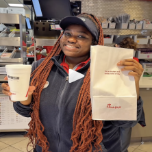 UL Student Union Chick-Fil-A worker holds up a bag of food and drink