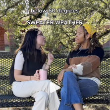 Below 60 degrees = sweather weather, two UL students sit on a bench talking about the weather