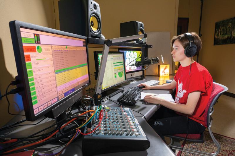 Kaley Mestayer sits in KampusFM's main control room.