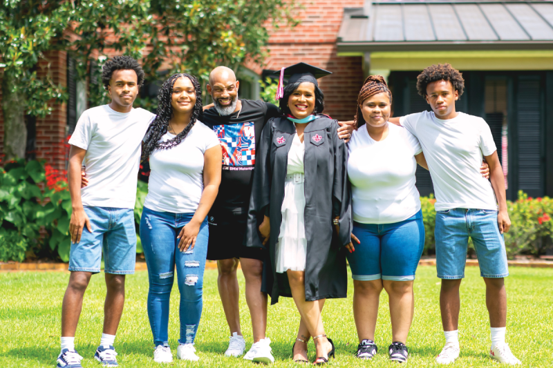 UL Lafayette M.Ed. graduate smiles for photo with her husband and four kids