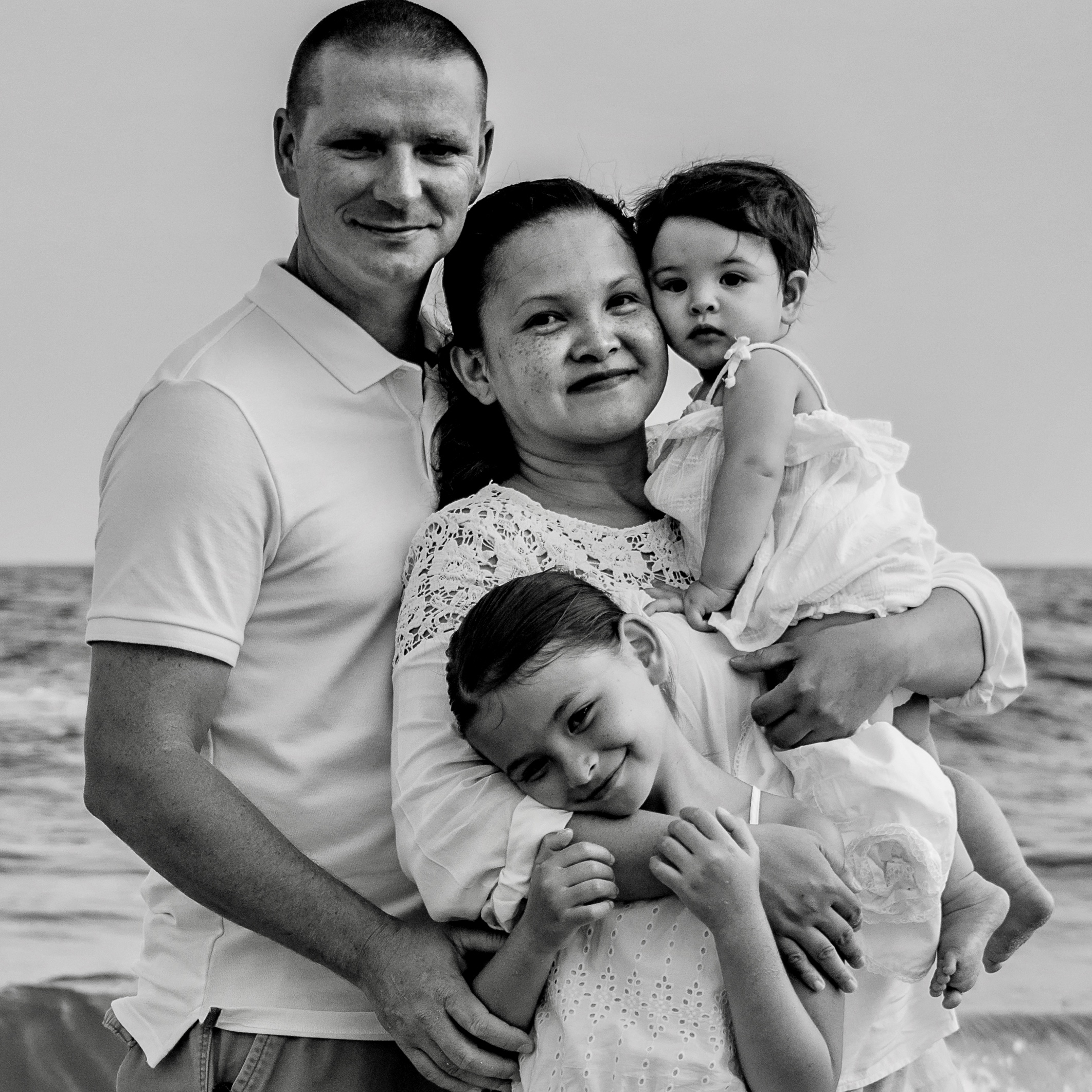Maria-Teresa King pictured with her husband and two daughters on a beach. King completed her degree in Health Services Administration from UL Lafayette.