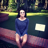 Kailee Clinton-Marikar sits beside Cypress Lake during her first visit to the University of Louisiana at Lafayette.