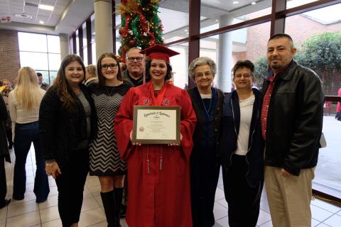 Miranda Wiles Domec stands with her family after UL Lafayette graduation.