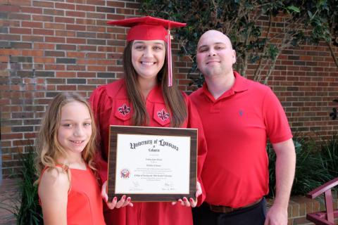 Destiny Theriot, UL Lafayette Health Services Administration graduate, with her daughter Ellen and husband Clint.