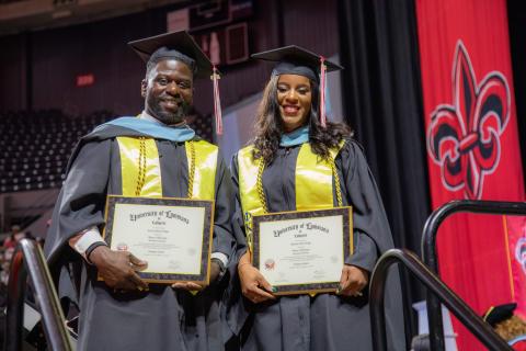 Master of Education graduates Kreig and Rekeisha Triggs hold their degree plaques during 2023 commencement.