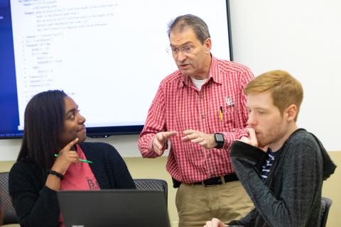 Dr. Michael Totaro, UL Lafayette Informatics program coordinator, teaching in front of a white board
