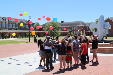 Dr. DeAnn Kalich leads sociology students in a balloon release as part of her death and dying class.