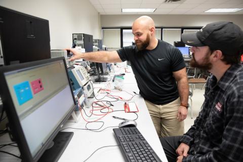 james Guillory works with a student as part of the Master of Science in Systems Technology online program.
